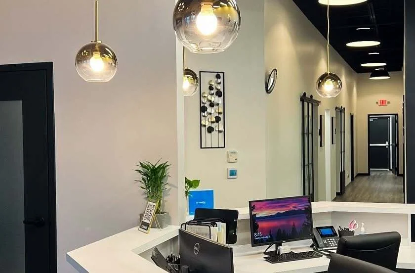 Reception desk with warm pendant lighting and welcoming decor