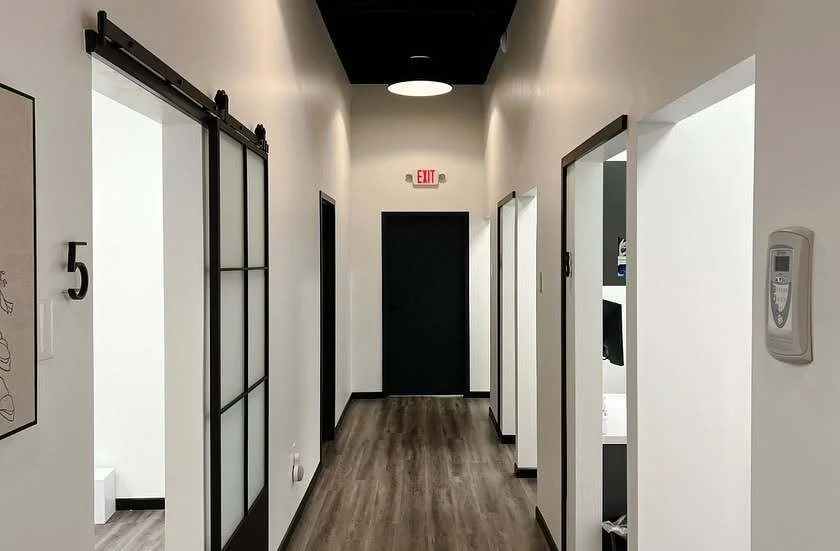 Bright hallway leading to numbered treatment operatories