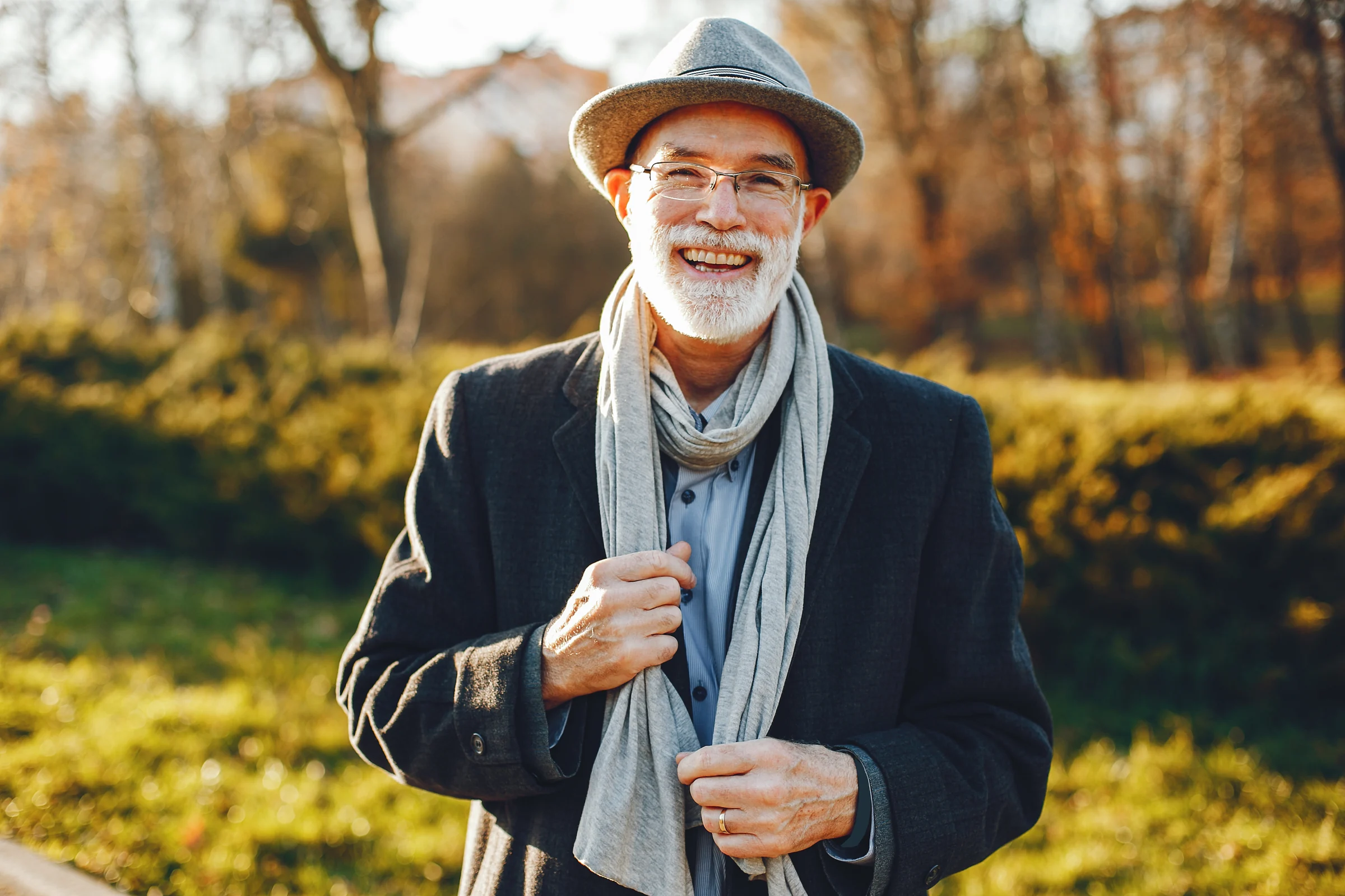 Patient smiling outdoors for dental implants
