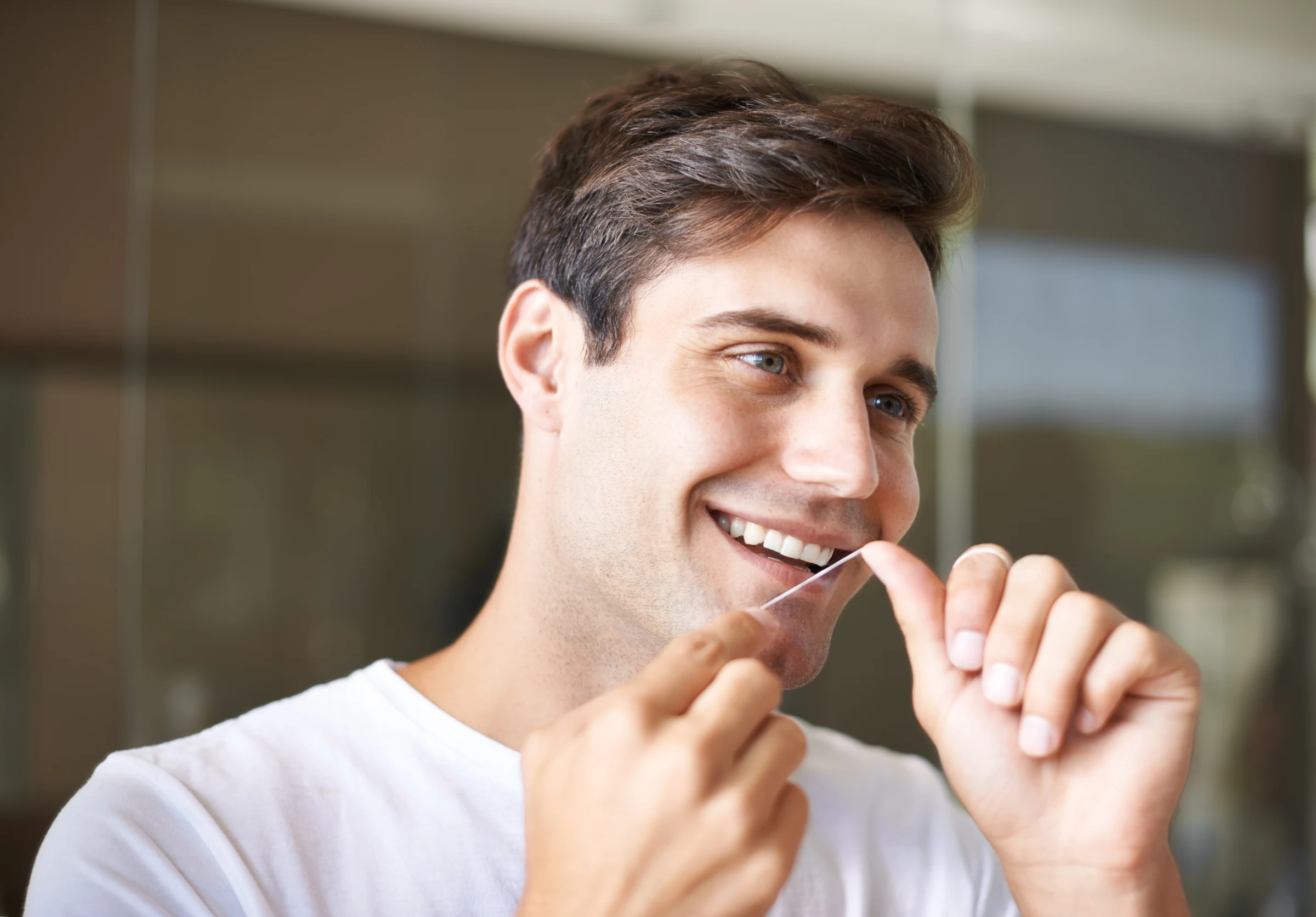 Person flossing their teeth
