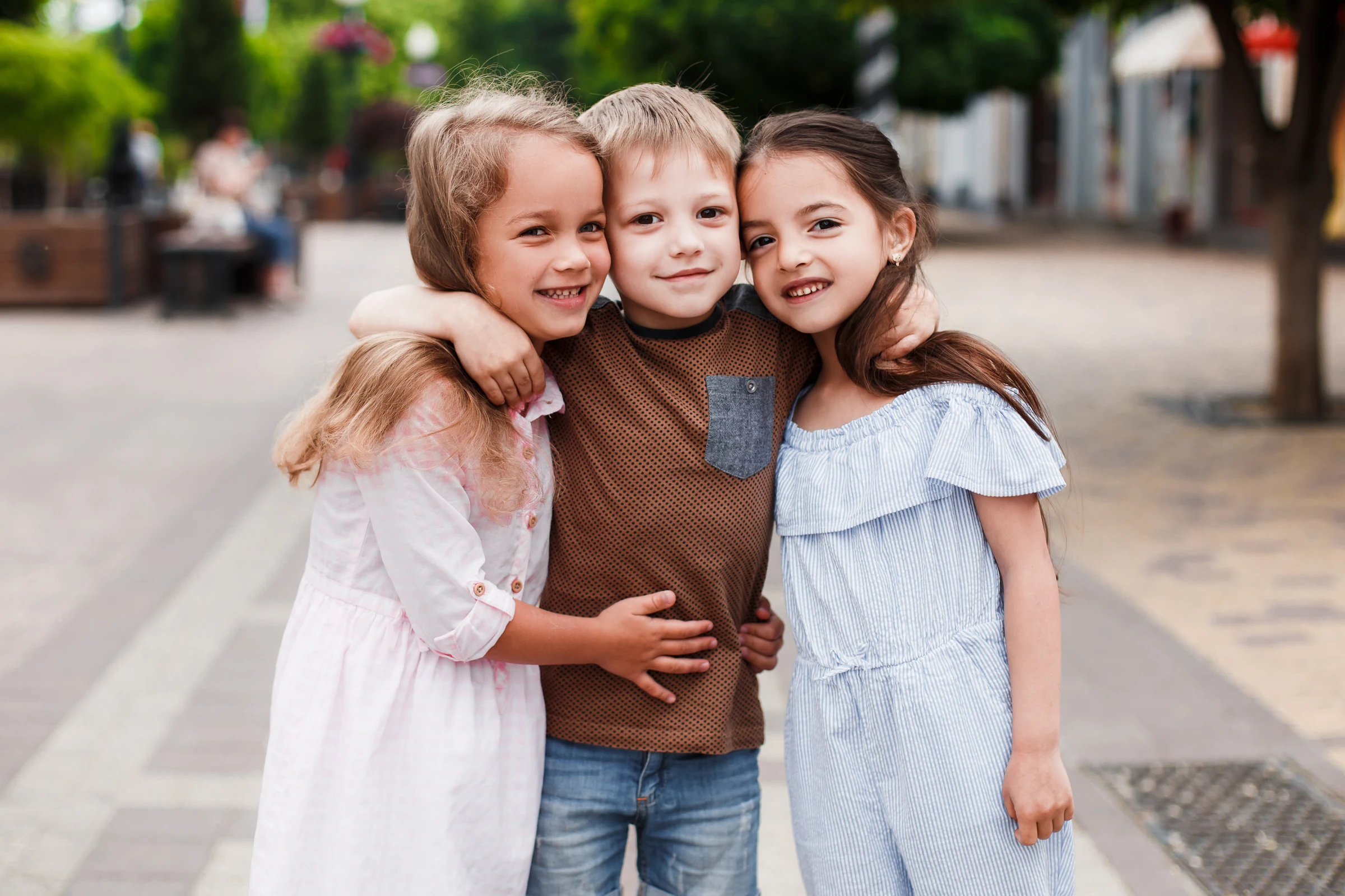 Three children smiling together